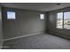 Light-filled bedroom featuring plush carpeting, neutral walls and three windows at 3354 S 180Th Ln, Goodyear, AZ 85338