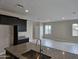 Kitchen with granite countertops, dark cabinets, and a view of the living room at 3354 S 180Th Ln, Goodyear, AZ 85338