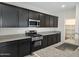Kitchen featuring dark cabinets, granite countertops, and stainless steel appliances at 3354 S 180Th Ln, Goodyear, AZ 85338