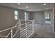 Bright open loft with neutral walls, plush carpeting and white and metal staircase railings at 3354 S 180Th Ln, Goodyear, AZ 85338