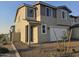 Two-story home boasts neutral stucco, dark trim, a two-car garage and desert landscaping at 3372 S 180Th Ln, Goodyear, AZ 85338