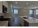 Kitchen features white cabinets, quartz countertops, stainless appliances, and kitchen island at 3372 S 180Th Ln, Goodyear, AZ 85338