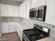 Well-lit kitchen with stainless steel appliances and white cabinetry at 3372 S 180Th Ln, Goodyear, AZ 85338