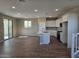 Spacious open-concept living room and kitchen with sliding glass doors and backyard access at 3372 S 180Th Ln, Goodyear, AZ 85338