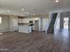 Open-concept living room with tile flooring, kitchen and staircase at 3372 S 180Th Ln, Goodyear, AZ 85338