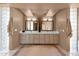 Bright bathroom featuring double sink vanity, decorative vases, framed mirrors, and light fixtures at 35180 N Boulder Pass, Scottsdale, AZ 85266