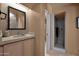 Modern bathroom featuring a gray stone countertop, a large mirror, and a walk-in shower at 35180 N Boulder Pass, Scottsdale, AZ 85266