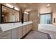 Dual vanity sinks and soaking tub in this Primary bathroom suite at 35180 N Boulder Pass, Scottsdale, AZ 85266