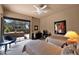 Cozy bedroom with two twin beds, desk area, neutral walls, and large sliding glass door with desert views at 35180 N Boulder Pass, Scottsdale, AZ 85266
