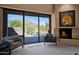 Bedroom view to an outdoor patio with a pool and desert mountain views at 35180 N Boulder Pass, Scottsdale, AZ 85266