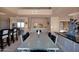 Open concept dining room with table and seating, flowing into kitchen and living room at 35180 N Boulder Pass, Scottsdale, AZ 85266