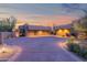 Long driveway leading to a home with multi-car garage and beautiful desert landscaping at 35180 N Boulder Pass, Scottsdale, AZ 85266
