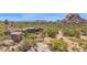 View of backyard with freeform pool and spa, and desert landscaping at 35180 N Boulder Pass, Scottsdale, AZ 85266