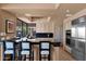 Kitchen with black countertop island and stainless steel appliances, offering a functional layout with a breakfast bar at 35180 N Boulder Pass, Scottsdale, AZ 85266