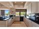 Bright kitchen with black countertops, tile floors and large window with desert views at 35180 N Boulder Pass, Scottsdale, AZ 85266