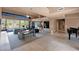 Spacious living room with large windows and bar area, designed for entertaining and showcasing art at 35180 N Boulder Pass, Scottsdale, AZ 85266