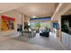 Spacious living room features large windows, a cozy fireplace, and stylish decor with beautiful mountain views at 35180 N Boulder Pass, Scottsdale, AZ 85266