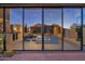 Open-concept living room with floor-to-ceiling windows offering stunning views and natural light, with modern decor at 35180 N Boulder Pass, Scottsdale, AZ 85266