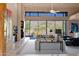 Bright living room with stunning views, a fireplace, and comfortable seating, perfect for entertaining guests at 35180 N Boulder Pass, Scottsdale, AZ 85266