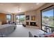 Spacious main bedroom featuring a sitting area, fireplace, large windows with stunning desert views at 35180 N Boulder Pass, Scottsdale, AZ 85266