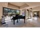Bright piano room with large windows featuring a view of a serene exterior courtyard at 35180 N Boulder Pass, Scottsdale, AZ 85266