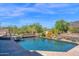 Inviting pool and spa featuring a waterfall, surrounded by beautiful desert landscaping and scenic mountain views at 35180 N Boulder Pass, Scottsdale, AZ 85266