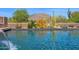 Sparkling pool with vibrant desert landscaping offering a serene outdoor retreat with a soothing waterfall feature at 35180 N Boulder Pass, Scottsdale, AZ 85266