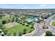 Community aerial view with a pool, tennis courts, and green spaces at 3634 E Perkinsville St, Gilbert, AZ 85295