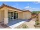 View of the covered back patio with ceiling fan and chairs overlooking the private backyard at 3634 E Perkinsville St, Gilbert, AZ 85295
