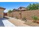 Private backyard featuring gravel landscaping, brick fence, and plant boxes at 3634 E Perkinsville St, Gilbert, AZ 85295