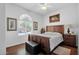Bright bedroom features a large window, wood floors, ceiling fan and elegant decor at 3634 E Perkinsville St, Gilbert, AZ 85295
