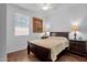 Light-filled bedroom features wood floors, ceiling fan and framed art at 3634 E Perkinsville St, Gilbert, AZ 85295