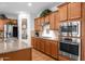 Kitchen with wood cabinets, granite counters, stainless appliances, a pantry and a center island at 3634 E Perkinsville St, Gilbert, AZ 85295