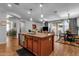 Modern kitchen with island including dishwasher that is open to living and dining areas at 3634 E Perkinsville St, Gilbert, AZ 85295