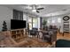 Cozy living room open to dining with neutral decor, ceiling fan, and backyard access at 3634 E Perkinsville St, Gilbert, AZ 85295