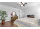 Comfortable main bedroom with wood floors, fan, dresser, and natural light at 3634 E Perkinsville St, Gilbert, AZ 85295