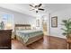 Spacious main bedroom with wood floors, fan, ensuite bathroom, and large windows at 3634 E Perkinsville St, Gilbert, AZ 85295