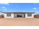 Spacious backyard featuring a covered patio with sliding glass doors and neutral stucco exterior at 37735 W Santa Maria St, Maricopa, AZ 85138
