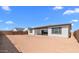 Expansive backyard features an open space and neutral stucco exterior with dark trim windows at 37735 W Santa Maria St, Maricopa, AZ 85138