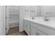 Bathroom with double sinks, white cabinetry, and a shower and tub combination at 37735 W Santa Maria St, Maricopa, AZ 85138