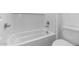 Clean white bathtub with white tile surround and modern fixtures at 37735 W Santa Maria St, Maricopa, AZ 85138