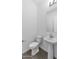 Small bathroom with modern fixtures, including a pedestal sink and toilet at 37735 W Santa Maria St, Maricopa, AZ 85138
