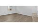 This bedroom features wood-look tile flooring and a window with blinds at 37735 W Santa Maria St, Maricopa, AZ 85138