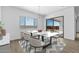 Bright dining room with modern chandelier, slider to patio, and view of desert landscape at 37735 W Santa Maria St, Maricopa, AZ 85138