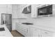 Well-equipped kitchen features stainless steel appliances, quartz countertops and a gas cooktop at 37735 W Santa Maria St, Maricopa, AZ 85138