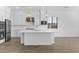 Bright kitchen features a large island, white cabinetry, and modern stainless steel appliances at 37735 W Santa Maria St, Maricopa, AZ 85138