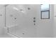This shower features white tile, built-in bench, and glass enclosure at 37735 W Santa Maria St, Maricopa, AZ 85138
