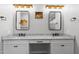 Bright bathroom features dual vanities, granite counters, modern fixtures, and a decorative painting at 3818 E Appaloosa Rd, Gilbert, AZ 85296