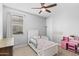 Bright bedroom with a neutral color palette, a large window, and a charming toddler bed at 3818 E Appaloosa Rd, Gilbert, AZ 85296