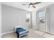 Bright bedroom featuring a ceiling fan, large windows, and a toddler bed at 3818 E Appaloosa Rd, Gilbert, AZ 85296